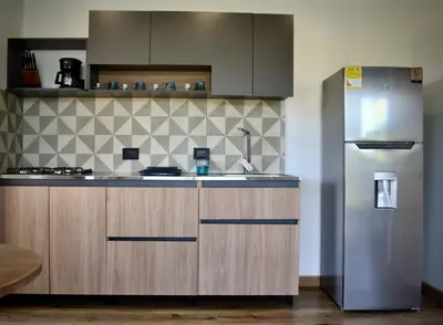 a kitchen with a stainless steel refrigerator at Cabaña del lago con Jacuzzi in Rionegro