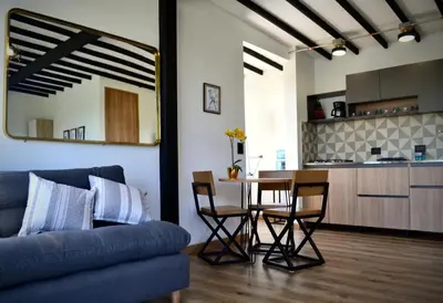 a living room with a couch and a table with chairs at Cabaña del lago con Jacuzzi in Rionegro