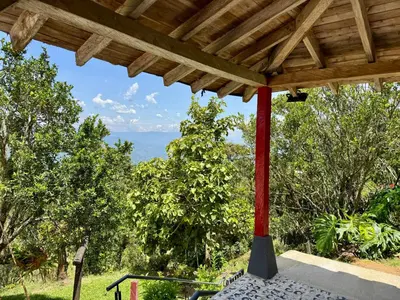 a view from the porch of a house with a pergola at Finca cafetera para descanso in Fredonia