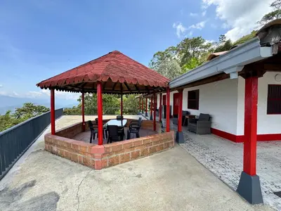 a gazebo on the side of a house at Finca cafetera para descanso in Fredonia