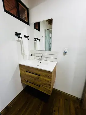 a bathroom with a sink and a mirror at Cabaña El Sueño de OPAD in Guarne