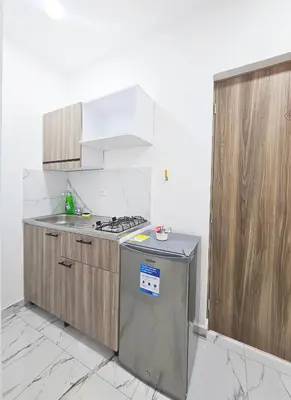 a kitchen with a sink and a stove top oven at Casa Eterna Campo Valdes in Medellín