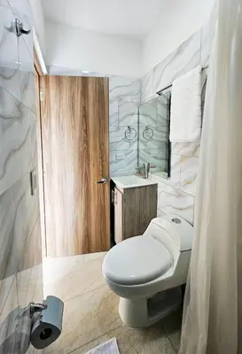 a bathroom with a toilet and a sink at Casa Eterna Campo Valdes in Medellín