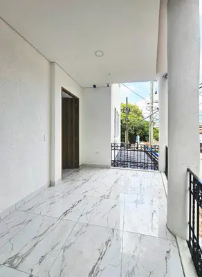 an empty room with white walls and a marble floor at Casa Eterna Campo Valdes in Medellín