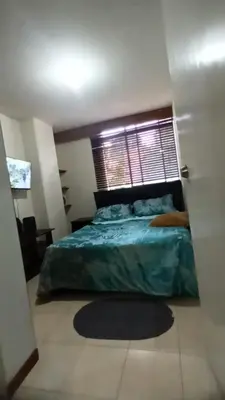 a bedroom with a bed and a window at Central apartment with air conditioning in Medellín