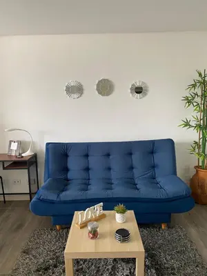 a blue couch in a living room with a coffee table at Class 48 Exclusivo y elegante apartamento in Sabaneta