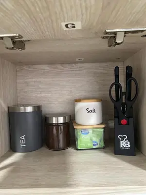 a shelf with two containers and a pair of scissors at Class 48 Exclusivo y elegante apartamento in Sabaneta