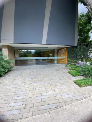 a large building with a stone courtyard with a large entrance at Class 48 Exclusivo y elegante apartamento in Sabaneta