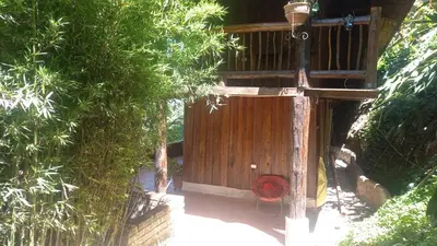 a wooden entrance to a house with trees at Cabaña los Juanes, Jardin Antioquia in Jardin
