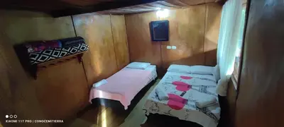a small room with two beds and a window at Cabaña los Juanes, Jardin Antioquia in Jardin