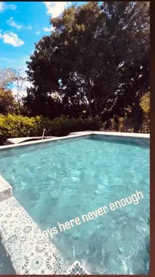 a swimming pool with blue water in a yard at La Fonte di Luce in Santa Fe de Antioquia