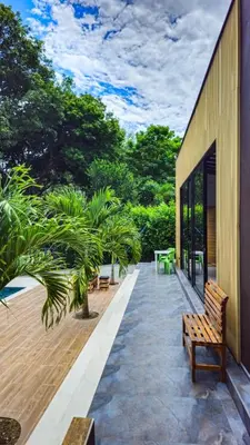 a patio with a wooden bench on the side of a building at La Fonte di Luce in Santa Fe de Antioquia