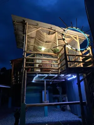 a building with a stack of wooden crates at night at Finca Crucytania in Titiribí