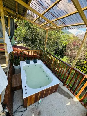 a hot tub on a deck with a roof at Finca Crucytania in Titiribí