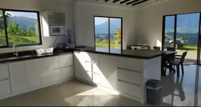 a kitchen with a counter top and some windows at Finca El Paraíso in Santa Fe de Antioquia