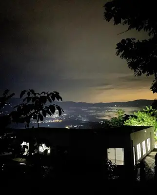 a view of a city at night from a house at Finca El Paraíso in Santa Fe de Antioquia