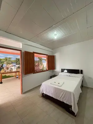 a bedroom with a bed and a view of the ocean at Hotel Marquez in Norcasia