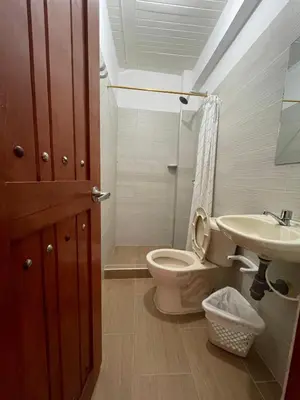 a bathroom with a toilet and a sink at Hotel Marquez in Norcasia