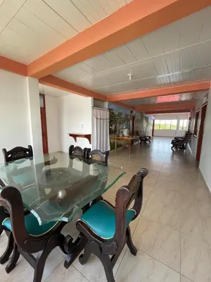 a dining room with a glass table and chairs at Hotel Marquez in Norcasia