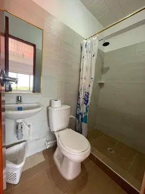 a bathroom with a toilet and a sink at Hotel Marquez in Norcasia