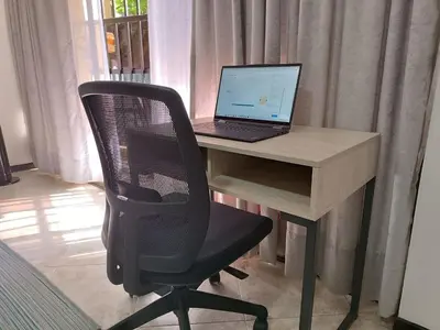 a desk with a laptop computer on top of it at Acogedor Apartaestudio en Laureles in Medellín
