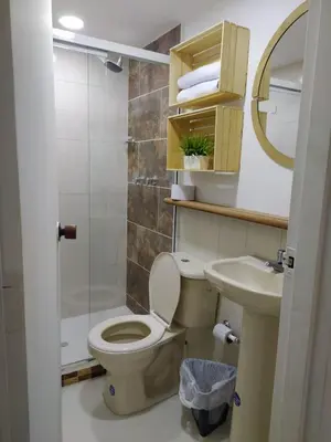 a bathroom with a toilet and a sink at Acogedor Apartaestudio en Laureles in Medellín