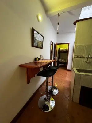 a kitchen with a bar with two stools in a room at Apartamento Hayalón in Betania