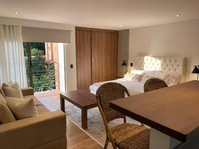 a bedroom with a bed and a table and chairs at Loft poblado con parqueadero in Medellín
