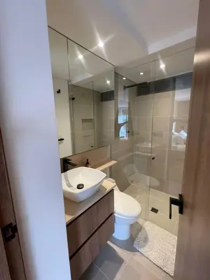 a bathroom with a sink and a toilet and a shower at Loft poblado con parqueadero in Medellín