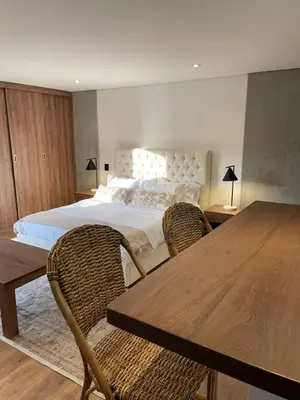 a bedroom with a bed and a table and chairs at Loft poblado con parqueadero in Medellín