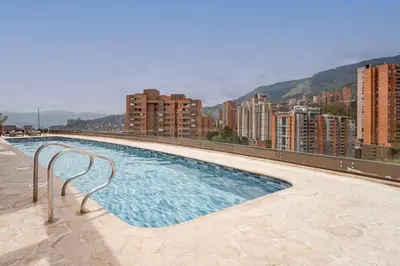 a swimming pool on the roof of a building at CLASS Suites in Medellín