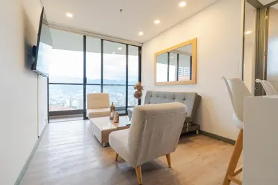 a living room with a couch and a table at CLASS Suites in Medellín
