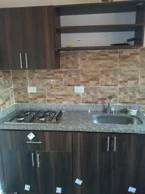 a kitchen counter with a sink and a stove at COMODOS APARTAMENTOS EN LA MEJOR ZONA DE MEDELLIN LAURELES ESTADiO in Medellín