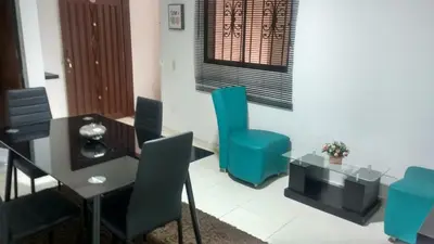 a dining room with a table and blue chairs at COMODOS APARTAMENTOS EN LA MEJOR ZONA DE MEDELLIN LAURELES ESTADiO in Medellín