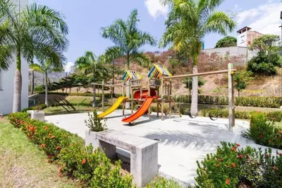 a playground with a slide in a park at Relájate y Disfruta, Apartamento con Piscina, Tobogán y Vista Espectacular en Santa Fé de Antioquia in Santa Fe de Antioquia