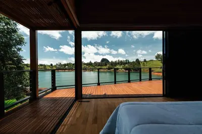 a bedroom with a view of a body of water at Sienna Casa del Lago in Guatapé