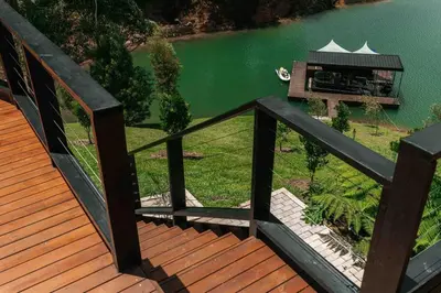 a wooden deck with a view of a body of water at Sienna Casa del Lago in Guatapé