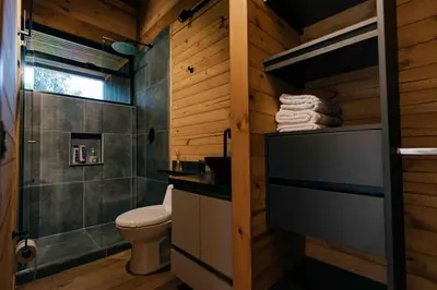 a bathroom with a toilet and a shower at Sienna Casa del Lago in Guatapé