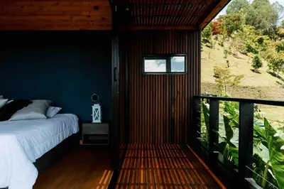 a bedroom with a bed on a balcony at Sienna Casa del Lago in Guatapé
