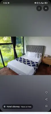 a bedroom with two beds and a window at family home in Honda