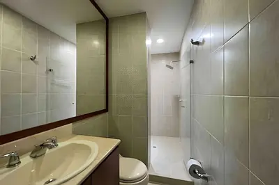 a bathroom with a sink and a shower and a toilet at Exclusive apto in Poblado in Medellín