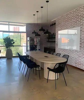 a dining room with a large wooden table and chairs at Exclusive apto in Poblado in Medellín