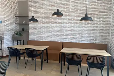 two tables and chairs in a restaurant with lights at Exclusive apto in Poblado in Medellín