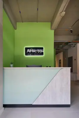 an office with a sign on a green wall at Hotel Attic 33 in Medellín
