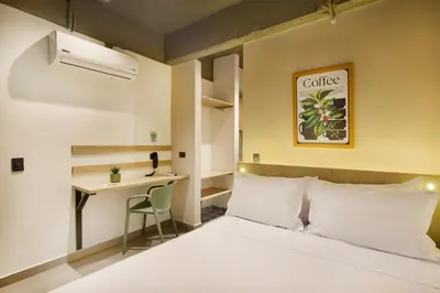 a hotel room with a bed and a desk at Hotel Attic 33 in Medellín