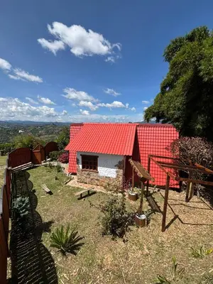 a red roofed house with a red roof at Glamping Montesereno in El Peñol