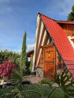 a small house with a red roof at Glamping Montesereno in El Peñol