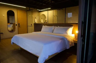 a bedroom with a large bed with white sheets and pillows at Hotel Casa Leon Rooftop in Rionegro