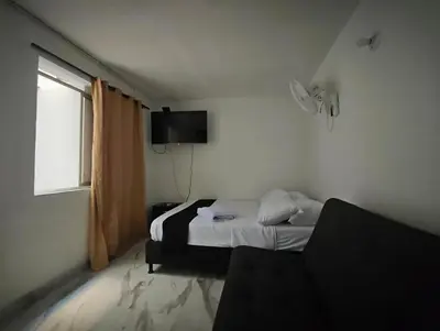 a bedroom with a bed and a television in it at Casa Eclat in Medellín