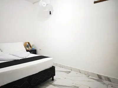 a bedroom with a bed with a spotlight on the wall at Casa Eclat in Medellín